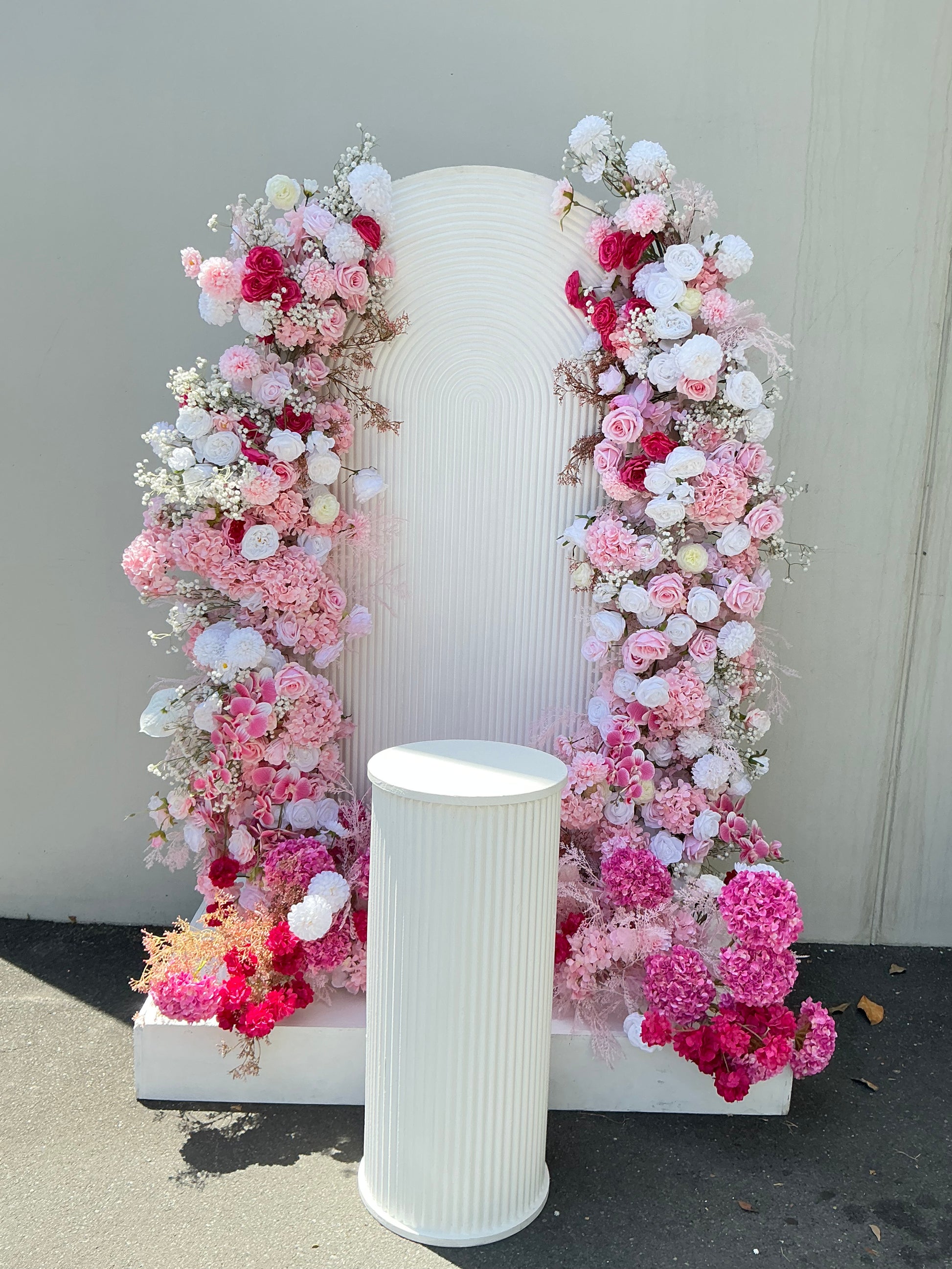 pink and white floral and ripple backdrop arrangements