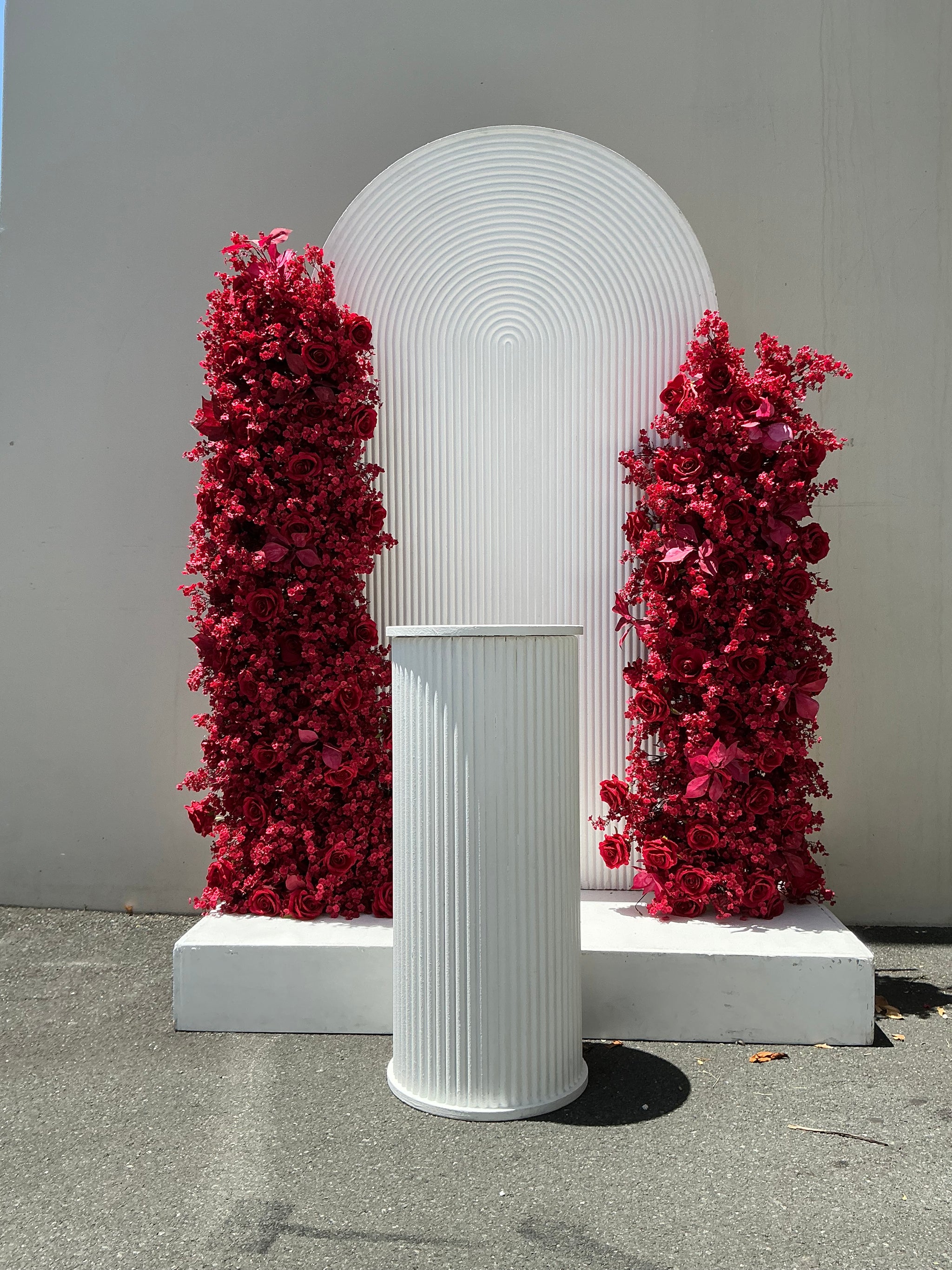 red rose floral and ripple backdrop arrangement