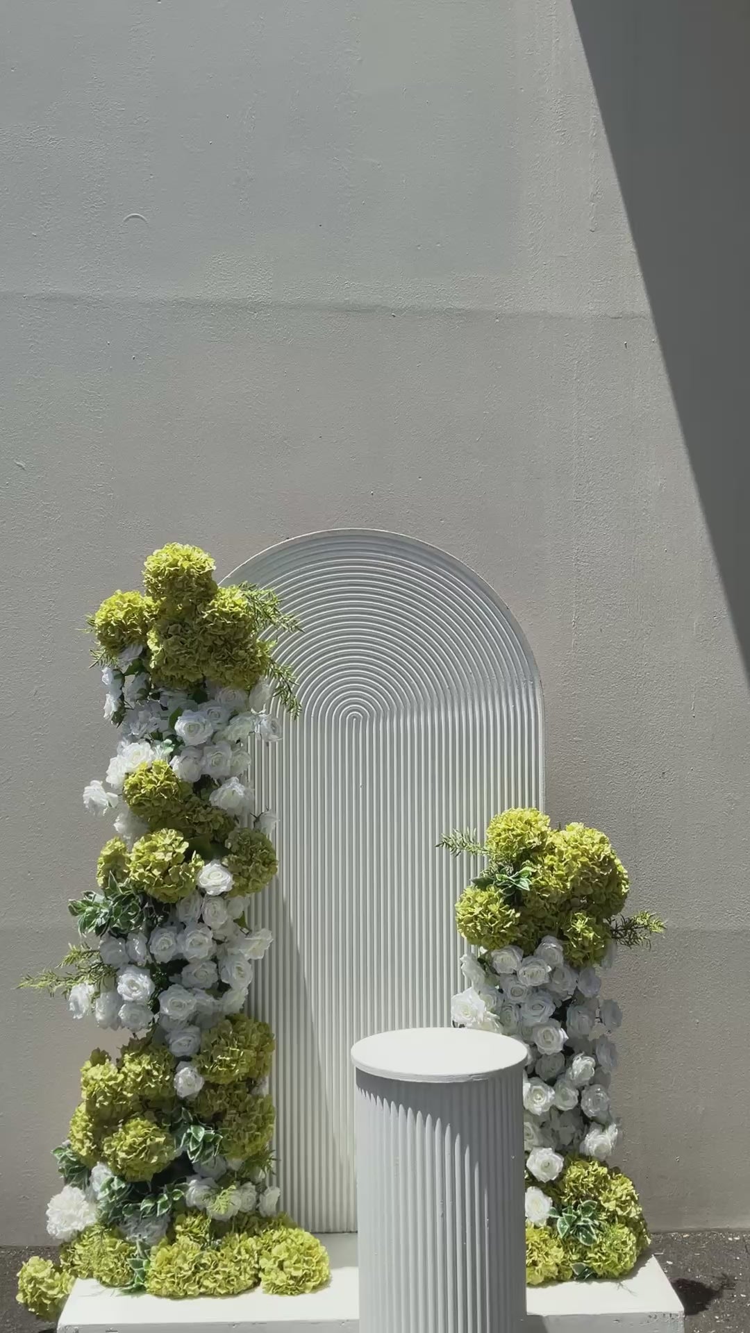 Green and white floral and ripple backdrop arrangement